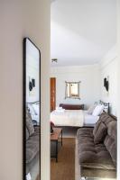 a living room with a bed and a mirror at Rokani Studio II at Kalavrita Center in Kalavrita