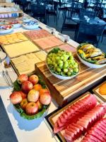 a table topped with bowls of different types of food at Porto Alto Resort - Vista Mar e Piscina 2 Quartos com Varanda ampla em L in Ipojuca