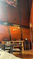 a dining room with a table and some chairs at Chalé Boutique Spa- Sauna seca, Jacuzzi , Rede suspensa in Campos do Jordão
