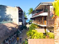 a city street with buildings and the ocean in the background at Suites by Eco Hotels in El Nido