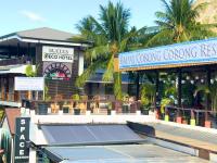 a tennis court in front of a building with a tennis court at Suites by Eco Hotels in El Nido