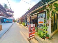a street with a sign in front of a store at Suites by Eco Hotels in El Nido
