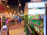 a group of people walking through a market at night at Suites by Eco Hotels in El Nido