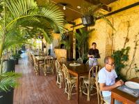 a man sitting at a table in a restaurant at Suites by Eco Hotels in El Nido