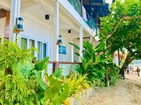 a building with a bunch of plants in front of it at Suites by Eco Hotels in El Nido