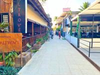 a street with people walking down a sidewalk at Suites by Eco Hotels in El Nido
