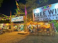 a group of people sitting at a food stand at night at Suites by Eco Hotels in El Nido