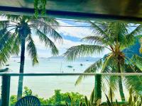 a view of the ocean from a resort with palm trees at Suites by Eco Hotels in El Nido