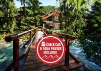 a sign on a wooden bridge in front of a cabin at Hotel Tri Studničky - Adult friendly in Demanovska Dolina