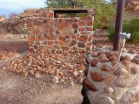 a stone wall with a pile of rocks around it at Hais Ra Tented Campsite in Khorixas