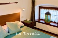 Posteľ alebo postele v izbe v ubytovaní Appartamento La Torretta