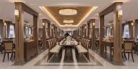 Paradise Legacy Cruise Halong في ها لونغ: غرفة طعام طويلة مع طاولة طويلة مع كراسي