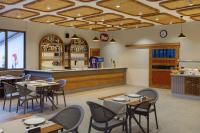 a restaurant with tables and chairs and a bar at Monk Resort Hotel Beldibi in Kemer