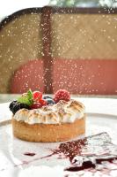 a dessert with fruit on a plate on a table at Grand Hotel Savoia in Genova