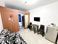 a hotel room with a bed and a table with chairs at Sea Residences Navigators in Manila