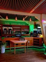 eine Bar mit einem Tisch davor in der Unterkunft Die Heilsbach gGmbH in Fischbach