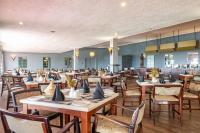 a dining room with wooden tables and chairs at Montclair Resort & Conference in Nyanga