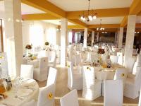 una stanza piena di tavoli bianchi e sedie bianche di Transylvania Hills a Şoimuş