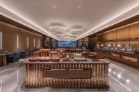 a hotel lobby with a buffet in the middle at Orange Crystal Hotel Zhizhu Garden East China Normal University Minhang District Shanghai in Shanghai