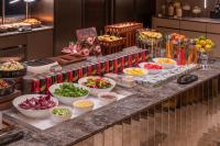 a buffet with bowls of food on a table at Orange Crystal Hotel Zhizhu Garden East China Normal University Minhang District Shanghai in Shanghai
