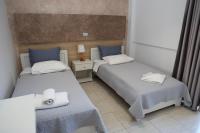A bed or beds in a room at Marie Hotel