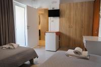A bed or beds in a room at Marie Hotel
