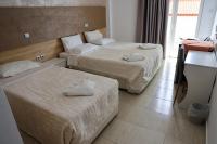 A bed or beds in a room at Marie Hotel
