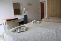 A bed or beds in a room at Marie Hotel
