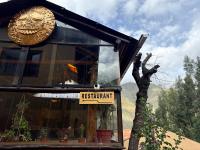 a restaurant sign on the front of a building at Andenes del Inca Hotel in Ollantaytambo