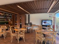 a restaurant with tables and chairs and a tv at Quinta da Amendoeira - Évora - The Farmhouse in Évora
