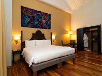 a bedroom with a bed and a painting on the wall at Novotel Cusco in Cusco