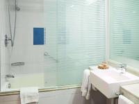 a bathroom with a sink and a shower and a tub at Novotel Cusco in Cusco