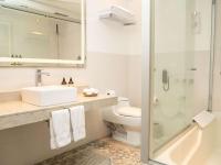 a bathroom with a toilet and a sink and a shower at Novotel Cusco in Cusco