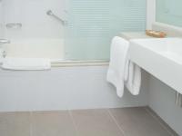 a bathroom with a white tub and a sink at Novotel Cusco in Cusco