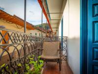 a chair on the balcony of a house at Novotel Cusco in Cusco