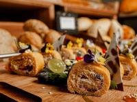 a wooden cutting board with a bunch of pastries at Novotel Cusco in Cusco