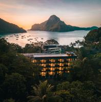 a view of a resort on the water with a mountain at The Funny Lion - El Nido in El Nido