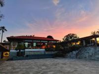 a building with a sunset in the background at Resort QSB - Um novo padrão de conforto e lazer no coração da cidade in Pirenópolis