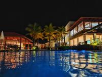 a swimming pool in front of a resort at night at Resort QSB - Um novo padrão de conforto e lazer no coração da cidade in Pirenópolis