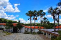 a view of a building with palm trees at Resort QSB - Um novo padrão de conforto e lazer no coração da cidade in Pirenópolis