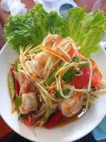 a plate of food with shrimp and lettuce on a table at Ban Nokngang campsite in Ban Nok Ngang