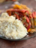 a plate of mashed potatoes and vegetables on a table at Nuevo Hotel Villa Giardino in Villa Giardino