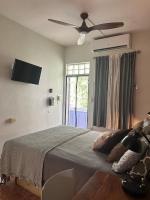 a bedroom with a bed with a ceiling fan and a window at Lower Price, More Style, Discount Studio In San Juan,Pr, Beach, Free Bikes in San Juan