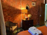 a room with a bed and a lamp and a mirror at Lower Price, More Style, Discount Studio In San Juan,Pr, Beach, Free Bikes in San Juan