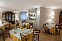 uma sala de jantar com mesas e cadeiras em um restaurante em Relais Borgofasceo em Ortovero