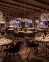 um restaurante com mesas, cadeiras e lustres em Hotell Klövsjöfjäll em Klövsjö