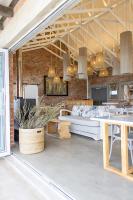 a large room with a couch and a table at Seeplaas Guesthouse in Groot Brak Rivier