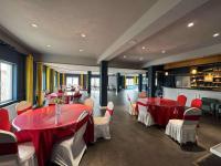 a dining room with red tables and white chairs at Terelj resort in Yoliin Hural