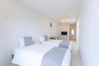 Hotel & Villa Seahorse MIYAKOJIMAにあるベッド