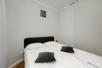 a white bed with two pillows on top of it at Apartment Wroclaw Jedności Narodowej by Noclegi Renters in Wrocław